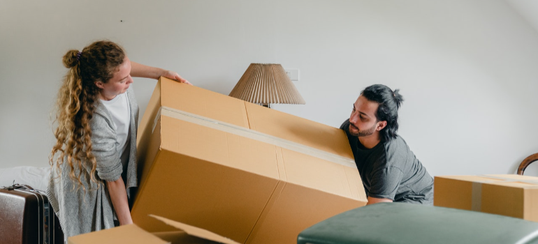 image 15 a man and a woman holding a cardboard box