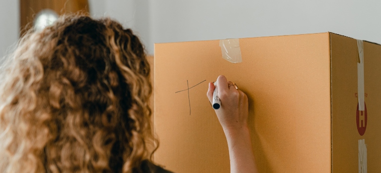 1 25 woman writing on the box