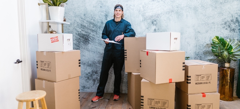 happy man monitoring moving boxes