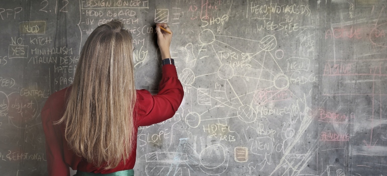 pexels andrea piacquadio 3769714 1 person writing on board