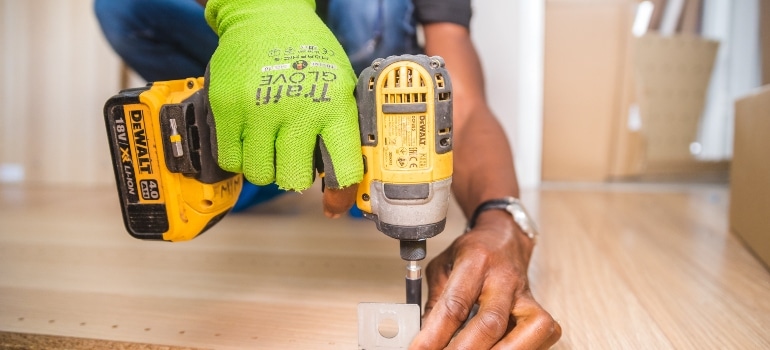 man drilling a piece of wood